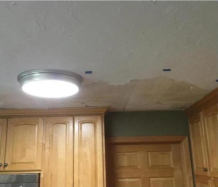 Water damaged ceiling in kitchen.